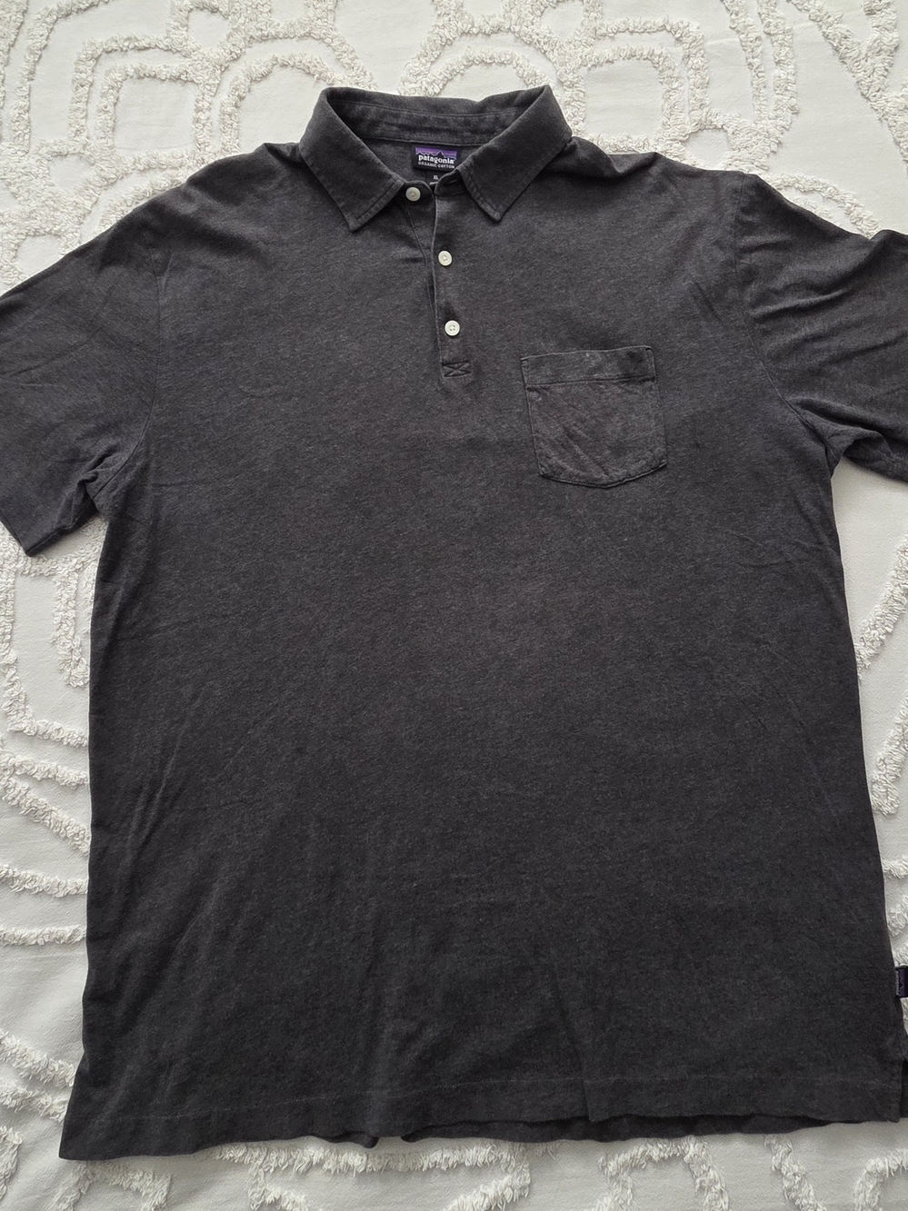 Patagonia polo style tshirt size XL has two small discoloration marks on pocket